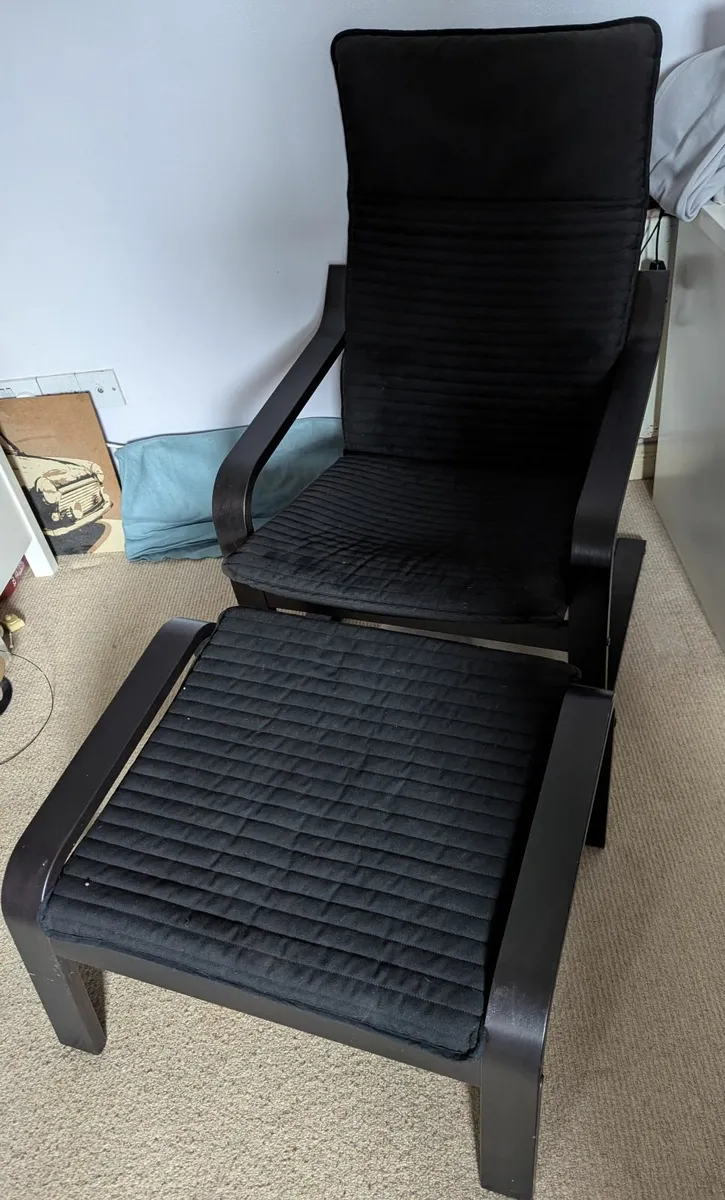Black IKEA poaug armchair and footstool