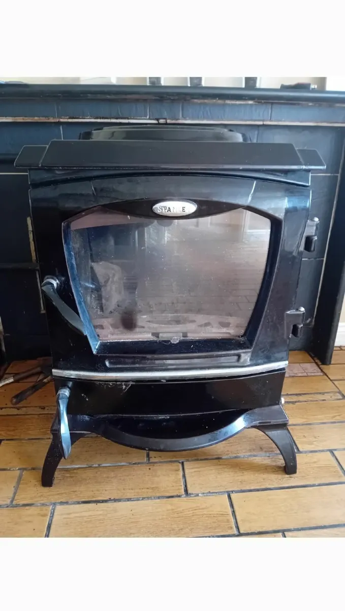 A solid fuel stove .,with back boiler heats 9 rods
