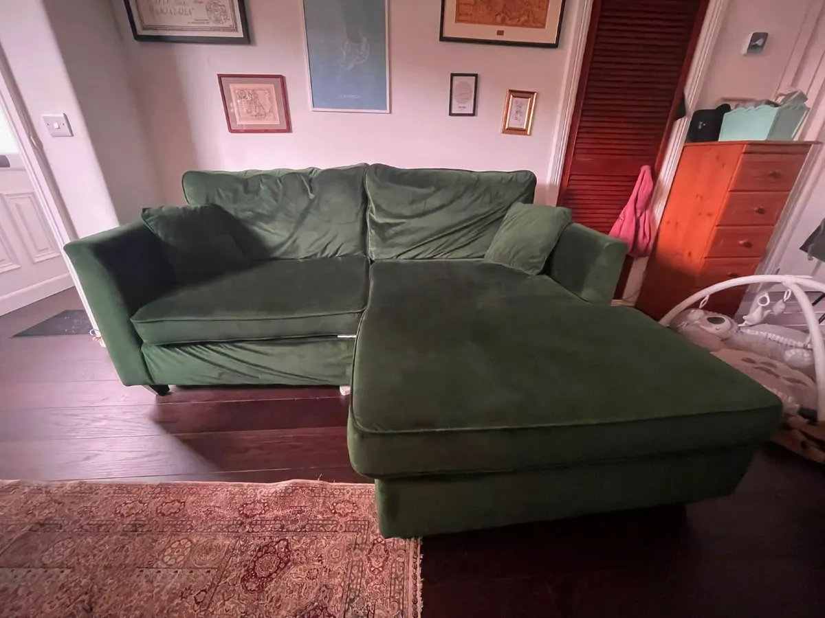Green L shaped velvet sofa