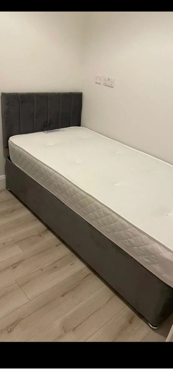 A  single bed with mattress