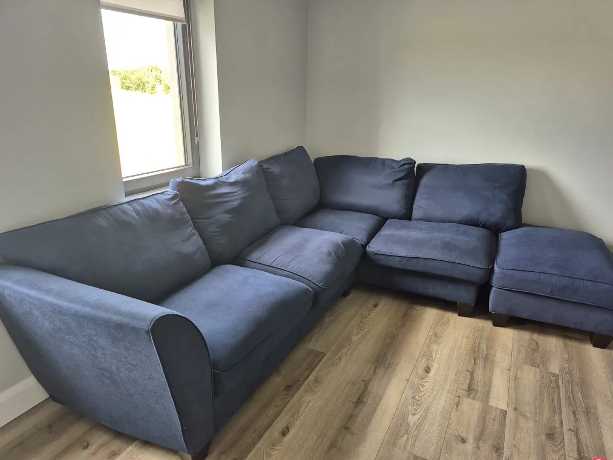 Corner sofa with footstool