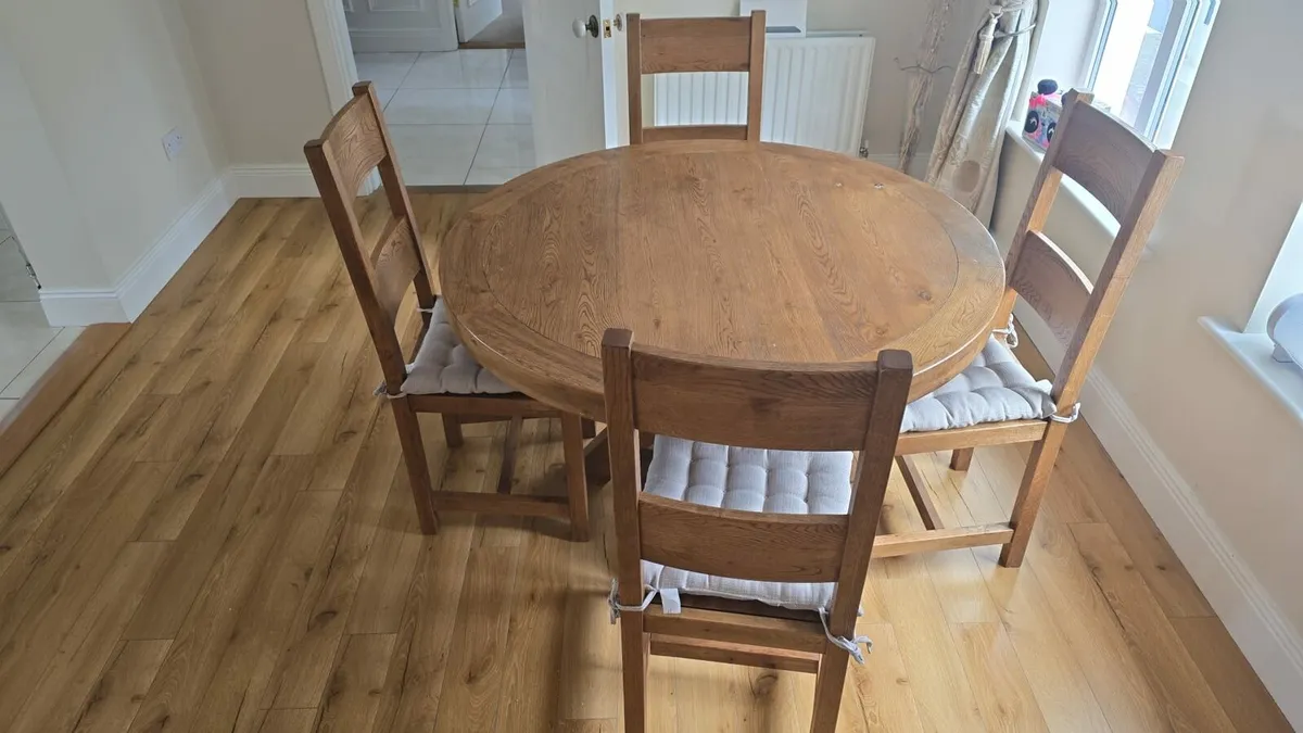 Solid oak dining table and four chairs. - Image 1