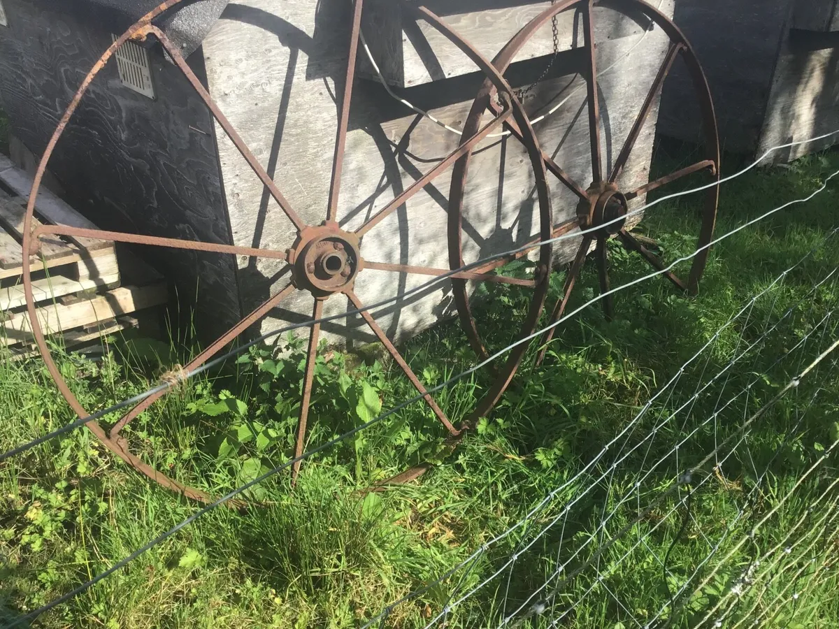 Metal hay rake wheels.