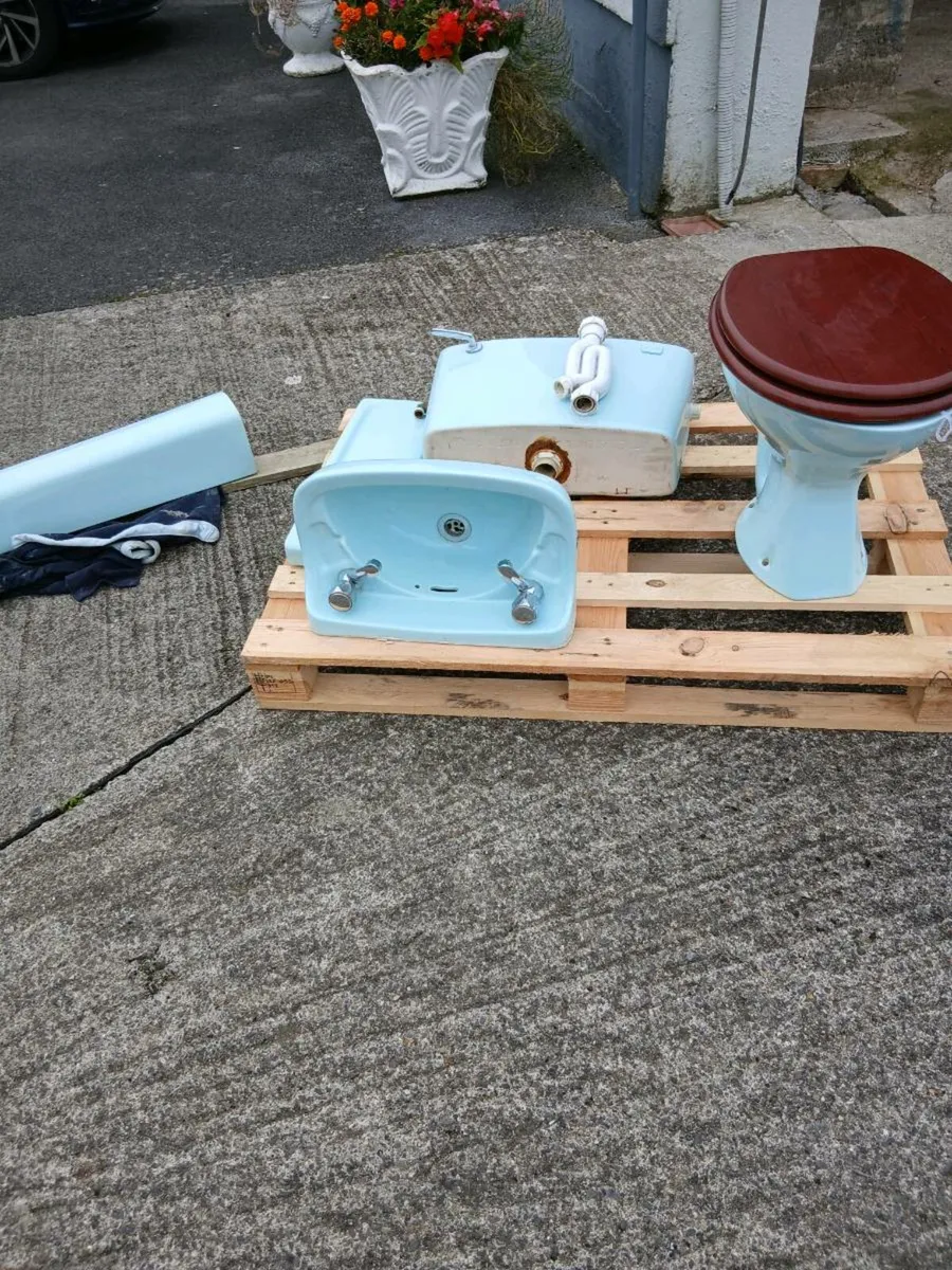 Bathroom toilet and sink - Image 1