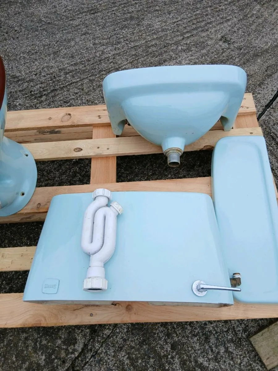 Bathroom toilet and sink - Image 3