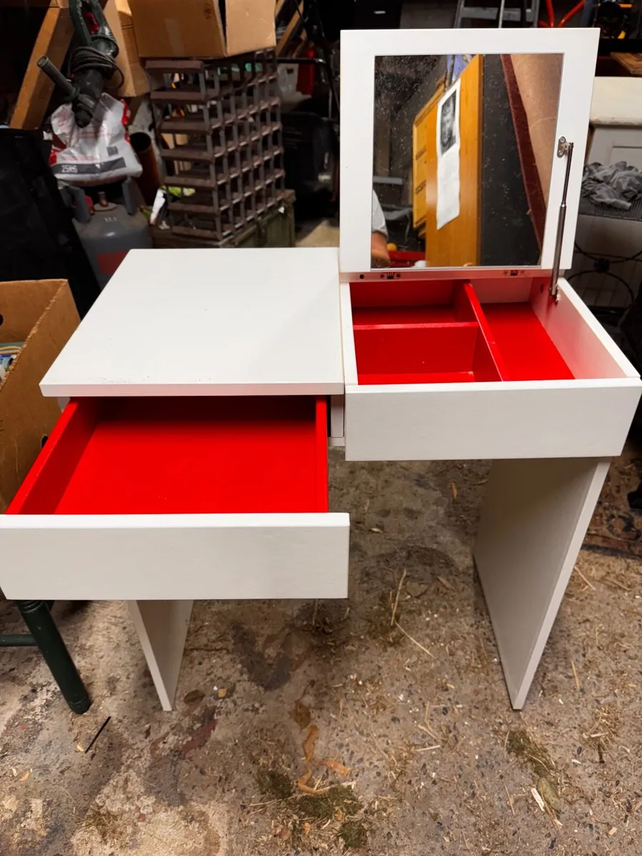 Dressing table with fold-up mirror