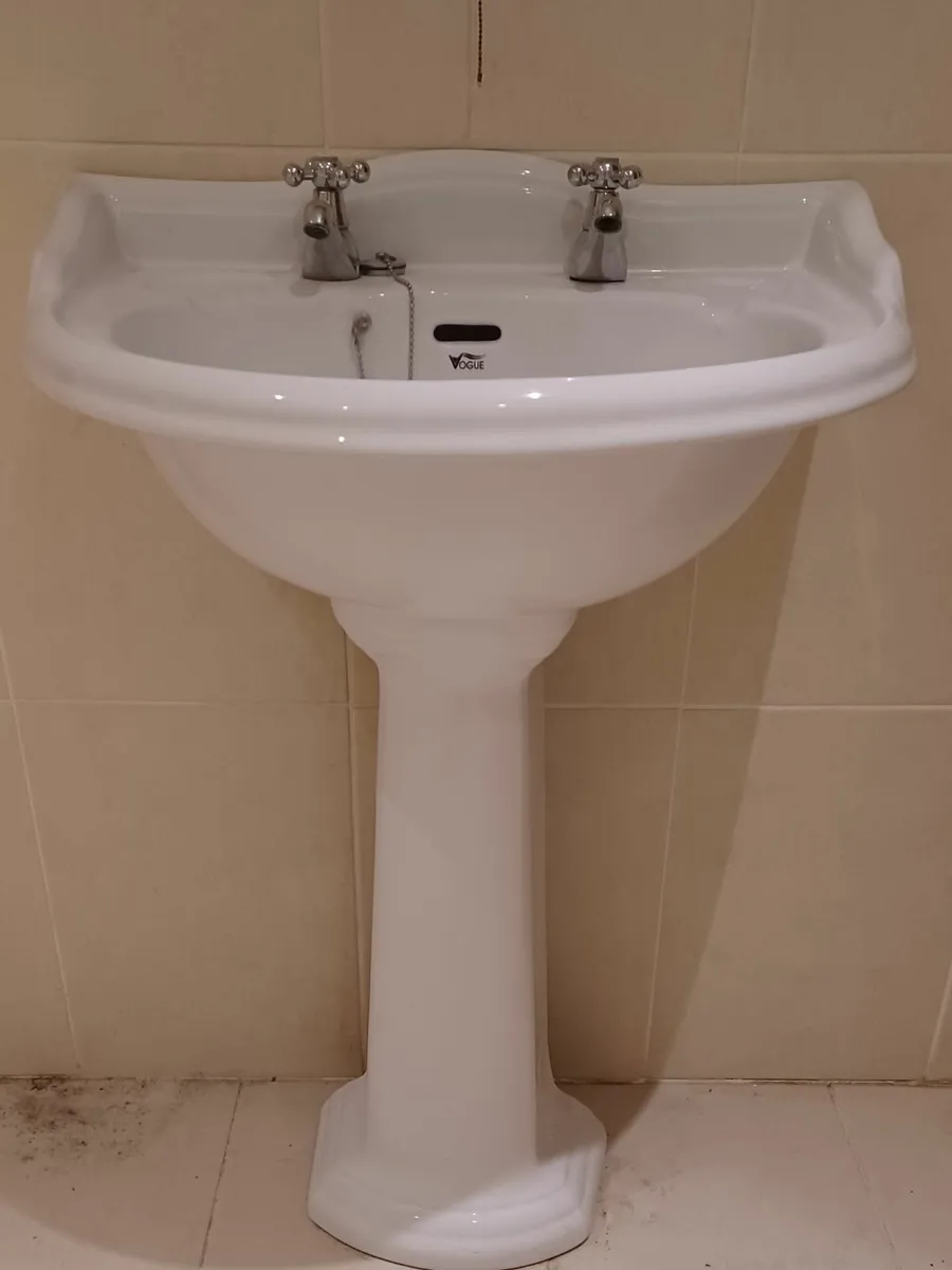 Bathroom toilet and sink - Image 2