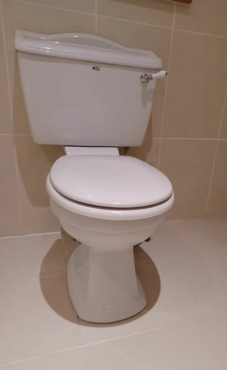 Bathroom toilet and sink - Image 4