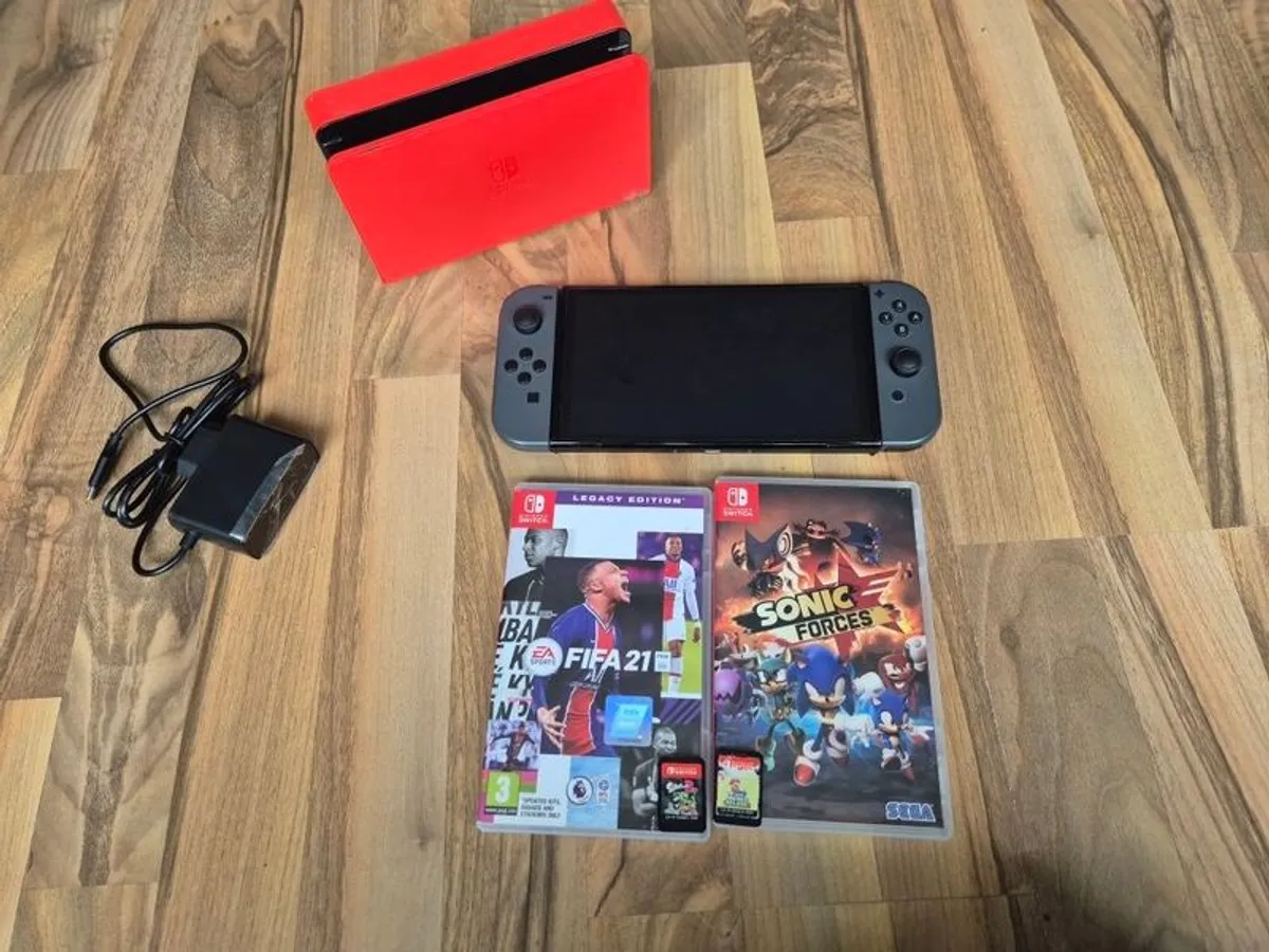 Nintendo Switch OLED with games and accessories - Image 1