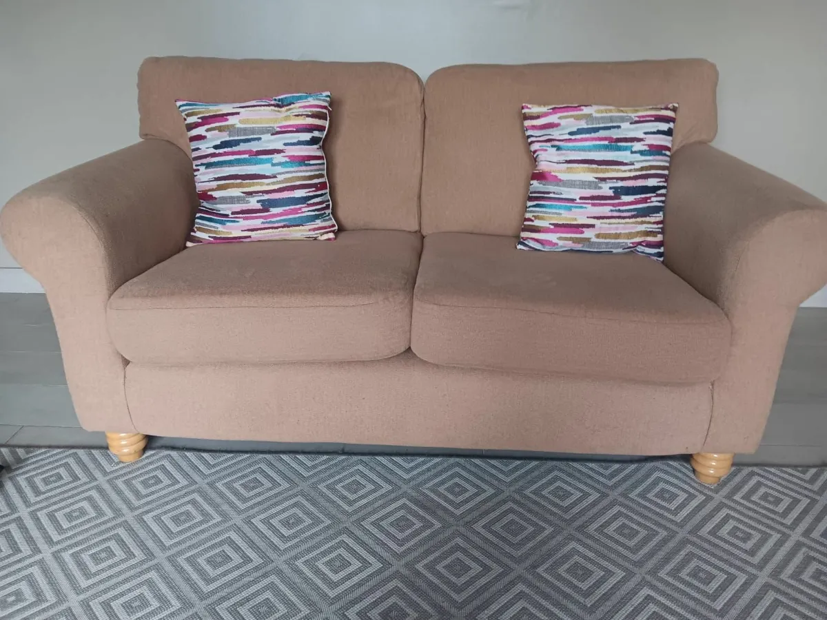 Blush pink two-seater couch