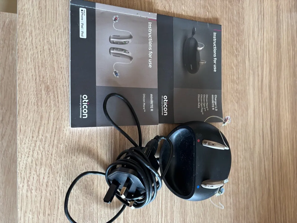 Oticon miniRiter hearing aid and charger - Image 1