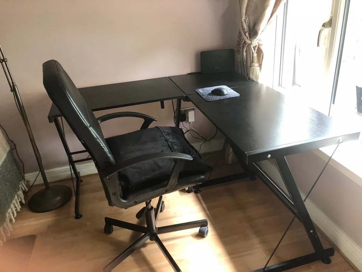 L shaped black office desk with leather chair