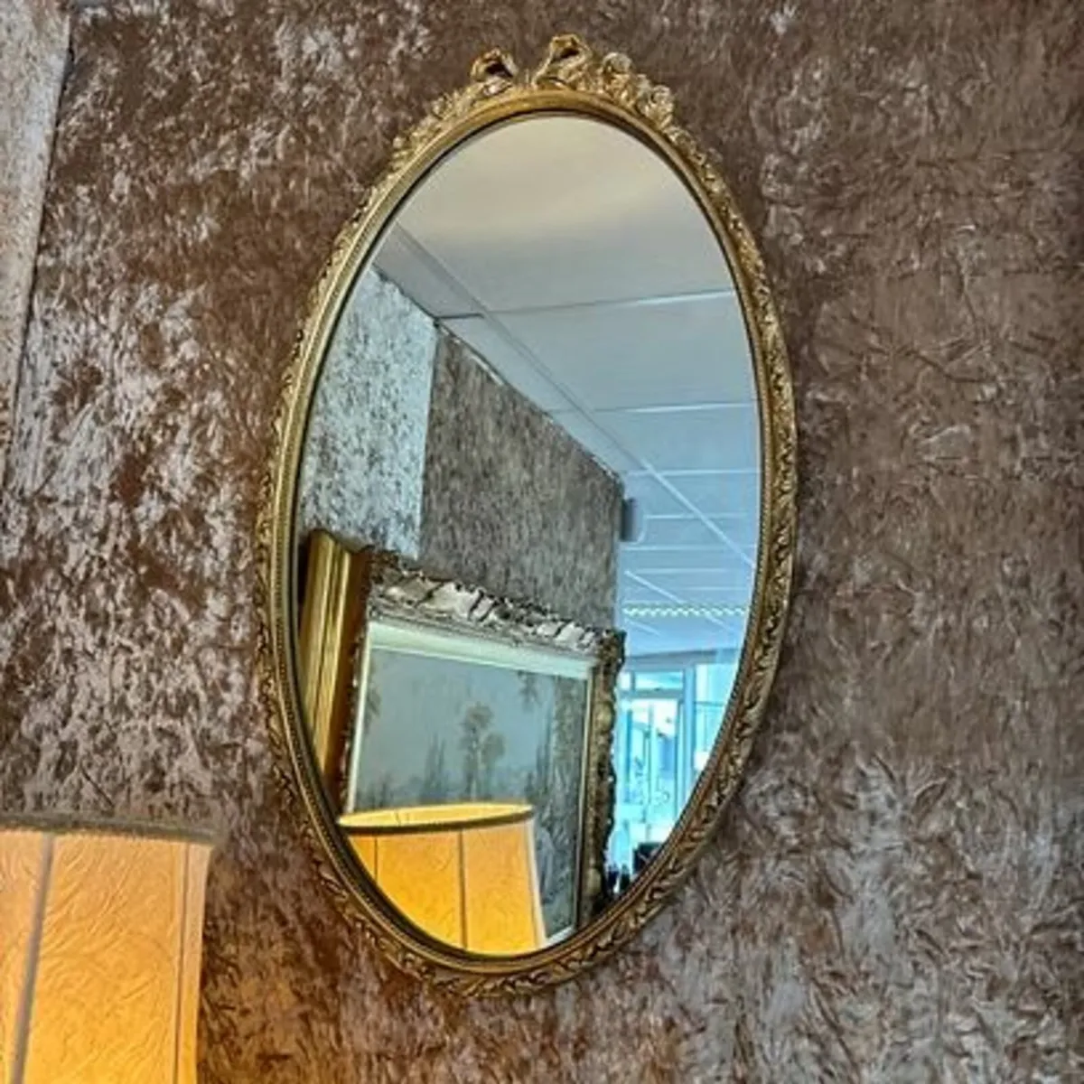 Beautiful ornate oval shaped bow on top wall mirro