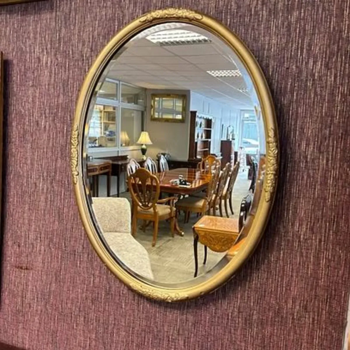 Beautiful ornate oval shaped bow on top wall mirro