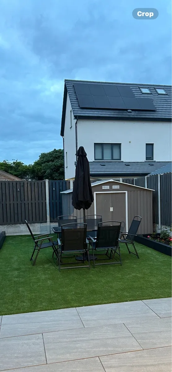 Black glass outdoor table with black chairs