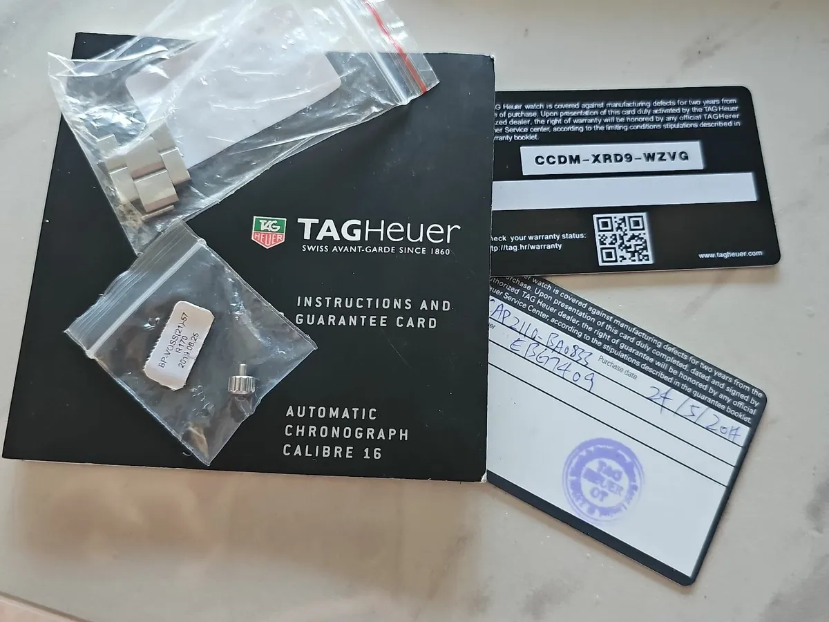 TAG Heuer original parts, warranty card, and paper - Image 1