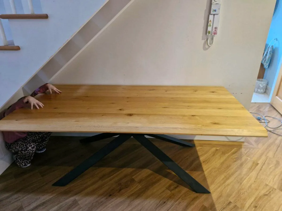 Solid oak dining table with black metal base - Image 1