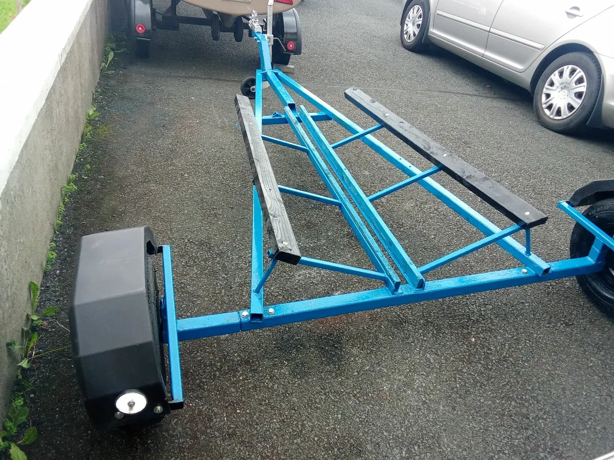 Boat trailer and life jackets. - Image 1