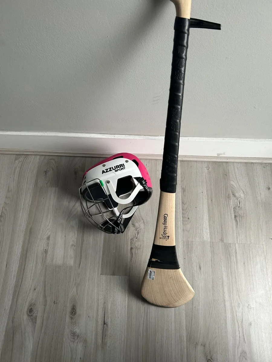 helmets with hurling sticks in perfec. - Image 1