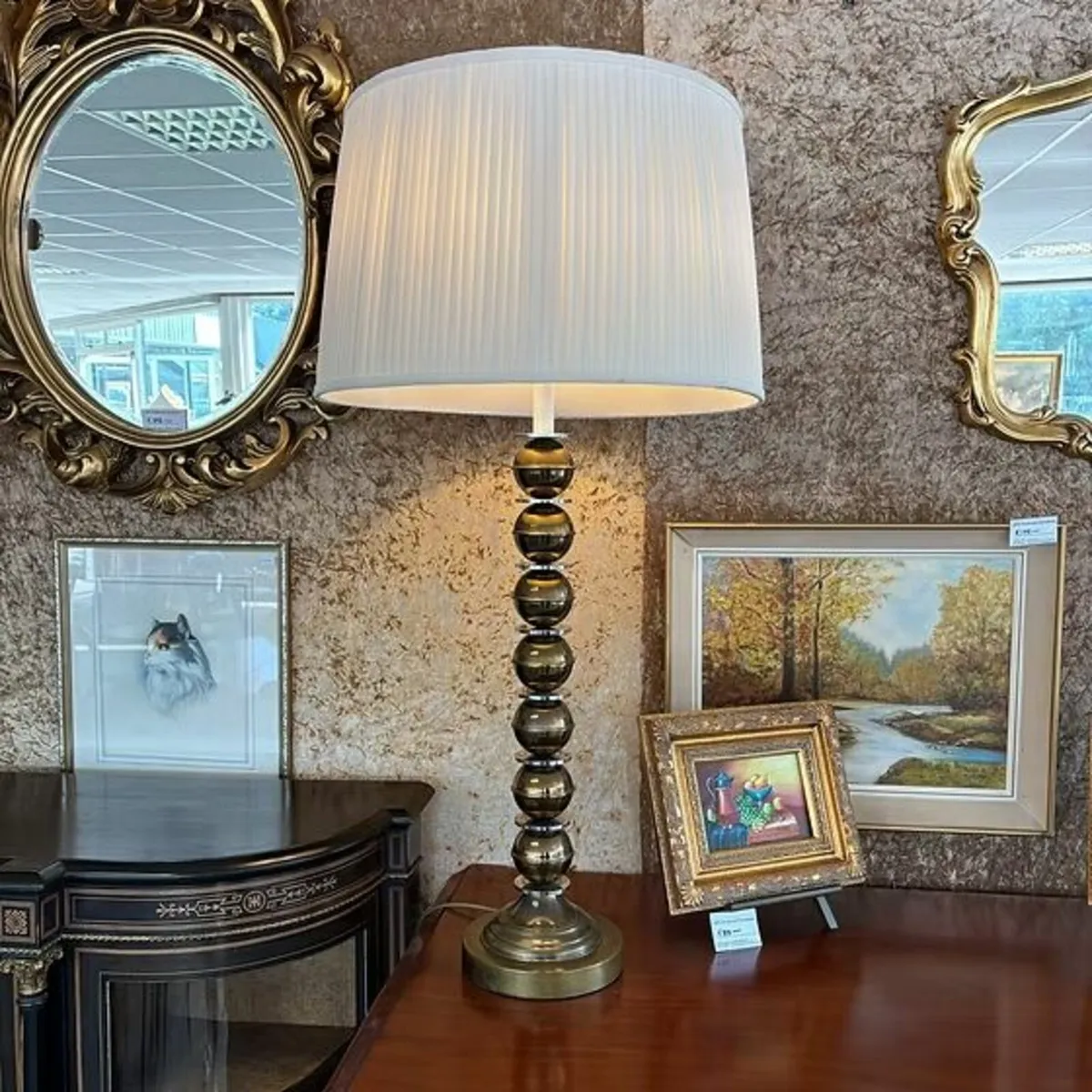 A contemporary table lamp with a pleated fabric la