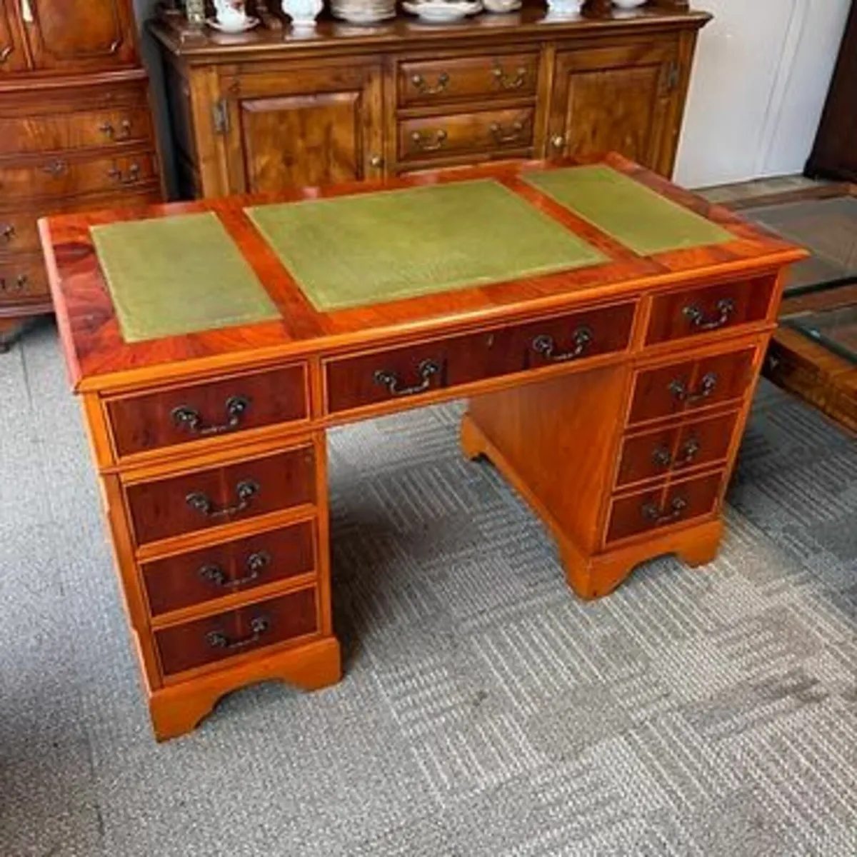 Yew green leather top twin pedestal writing desk
