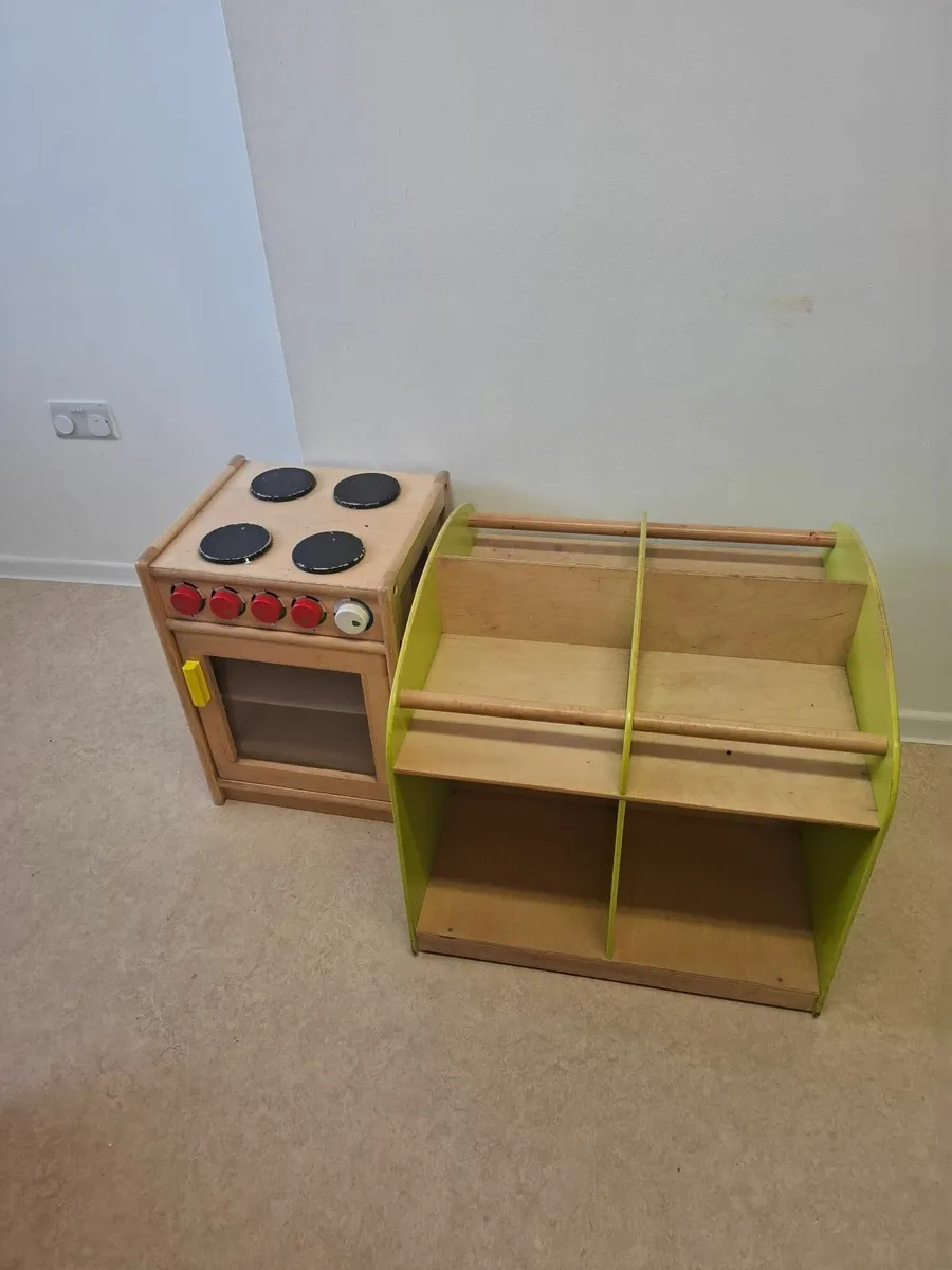 Wooden toy cooker and library on wheels
