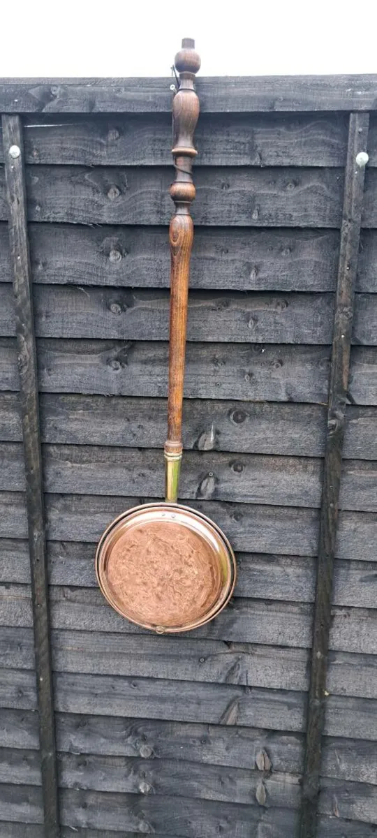Old copper bed warmer