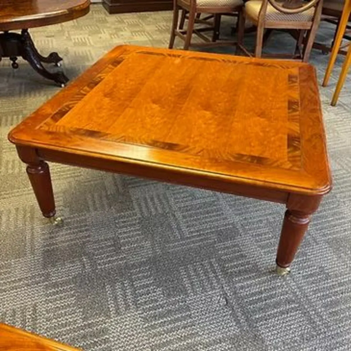 Beautiful rosewood coffee table on brass casters