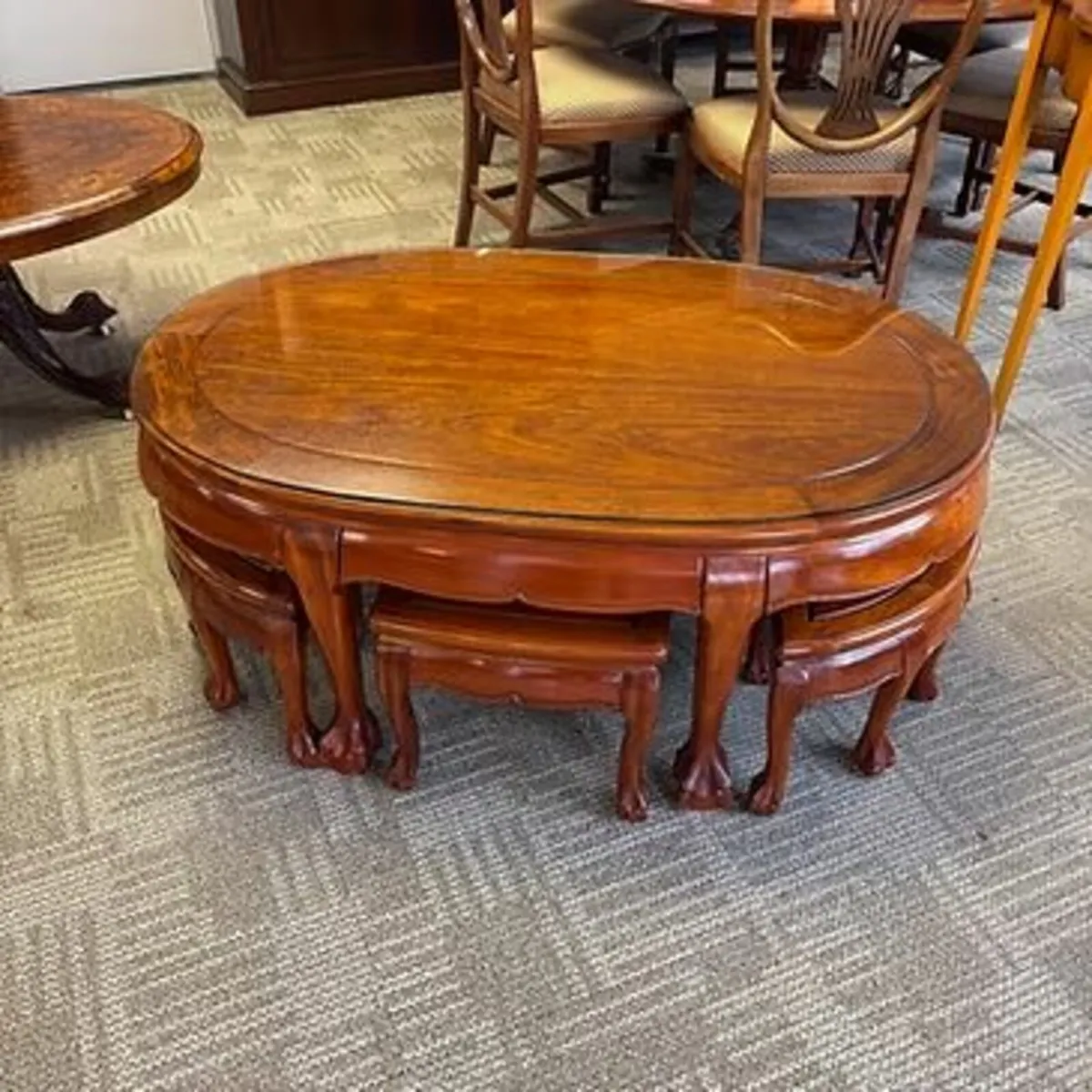 Oriental oval coffee table with six occasional tab
