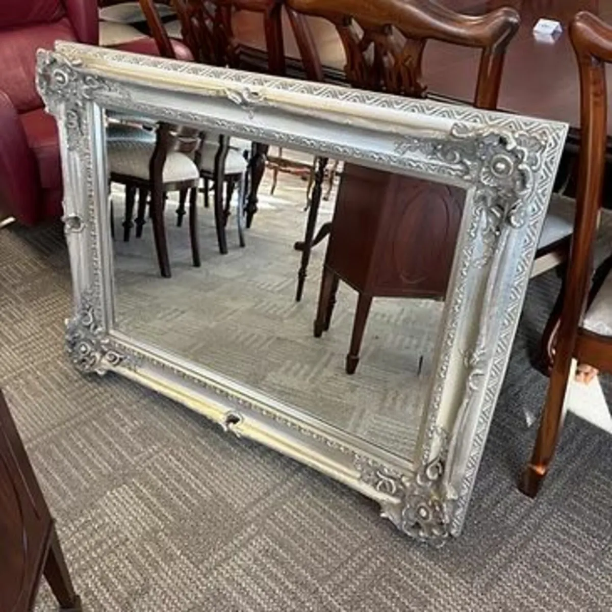 Ornate silver wall mirror. Swipe for additional ph