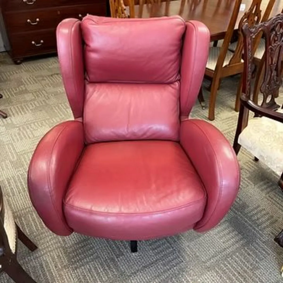 Romeo swivel red leather chair. Silver base. Swipe