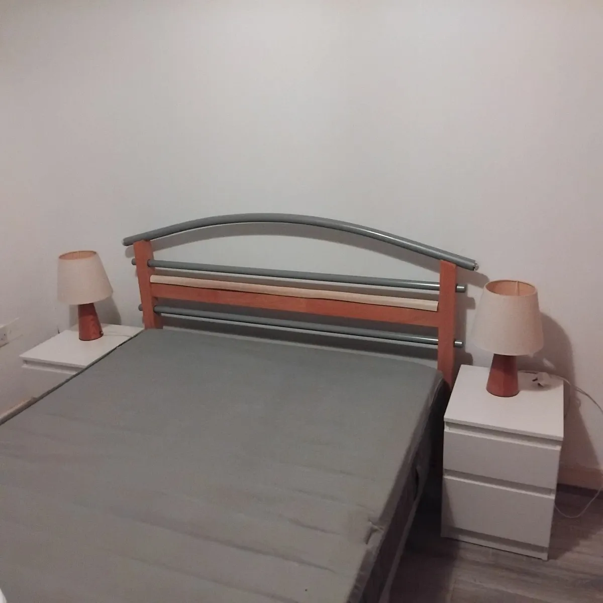 double bed with two cabinets and lamps - Image 1