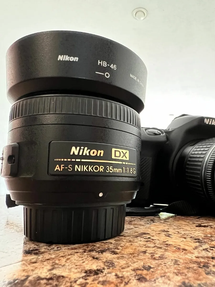 Nikon D5600 with 18-55mm and 35mm lenses + battery - Image 1
