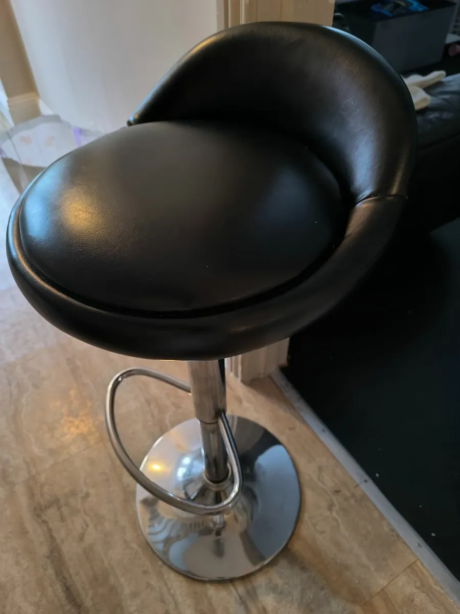 Two black leather high stools