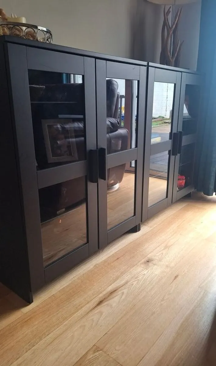 2 black cabinets with glass doors and shelves - Image 1