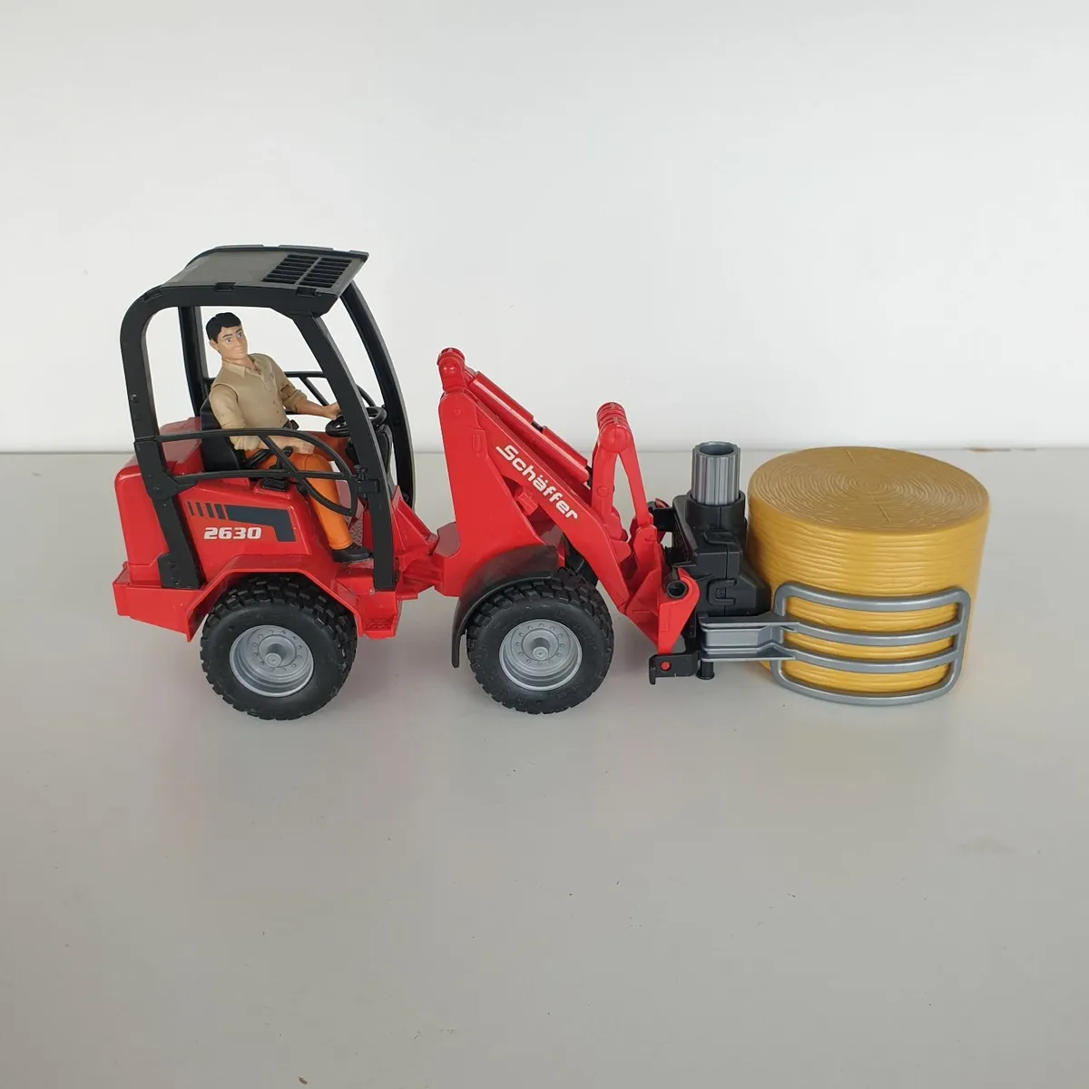 Bruder schaffer loader with driver & bale - Image 1
