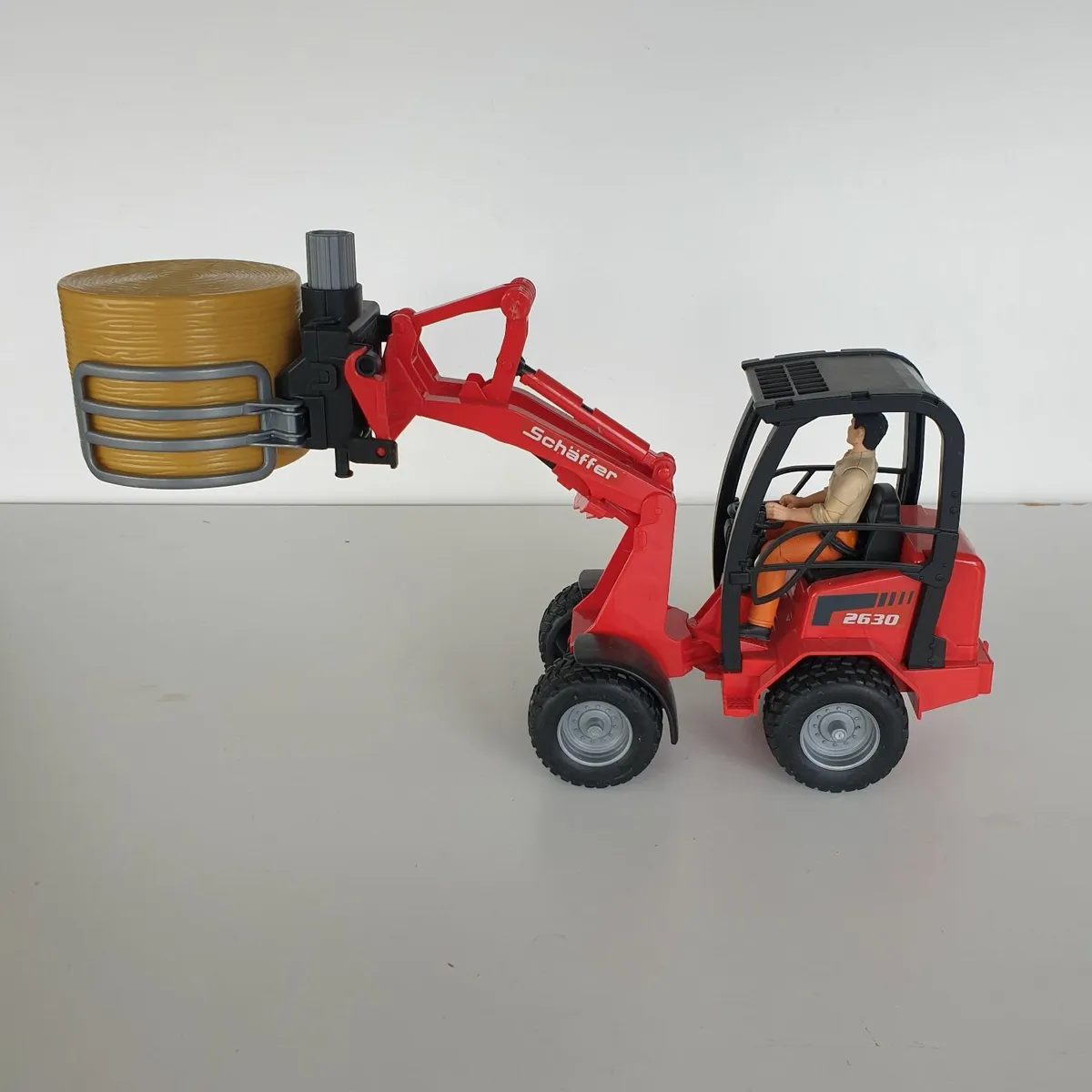 Bruder schaffer loader with driver & bale - Image 2