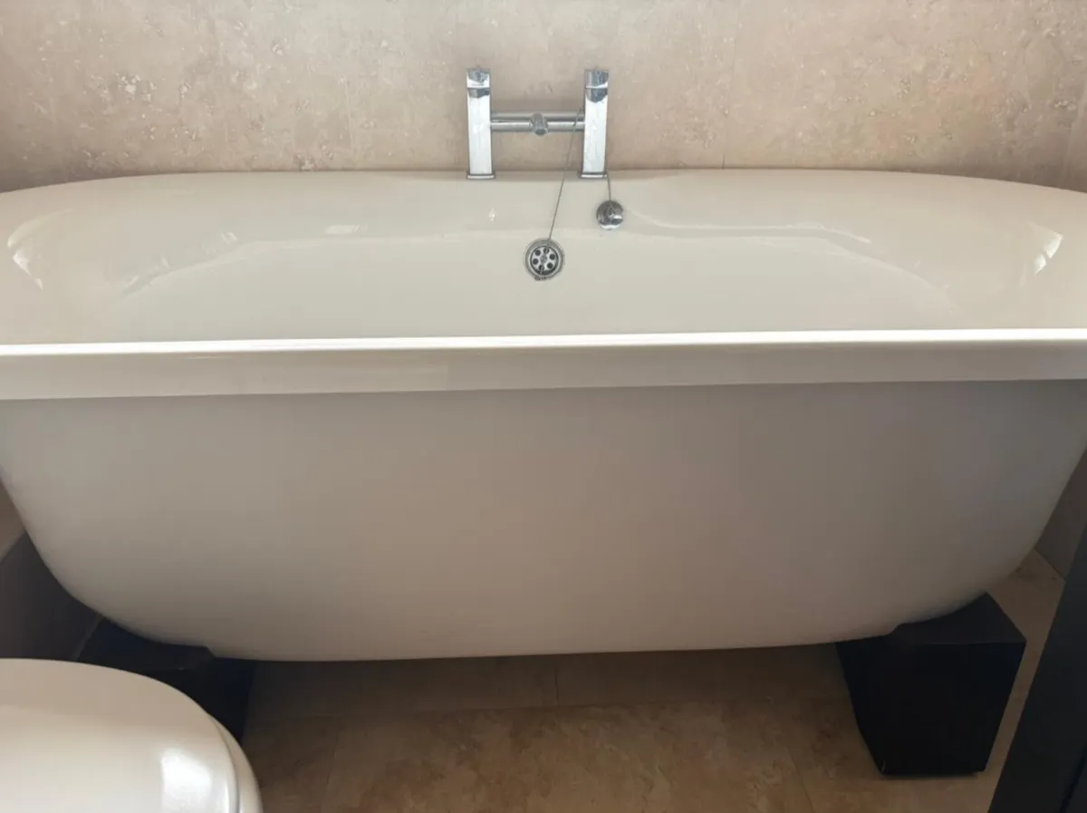 Standalone roll top bath with dark wood stand - Image 1