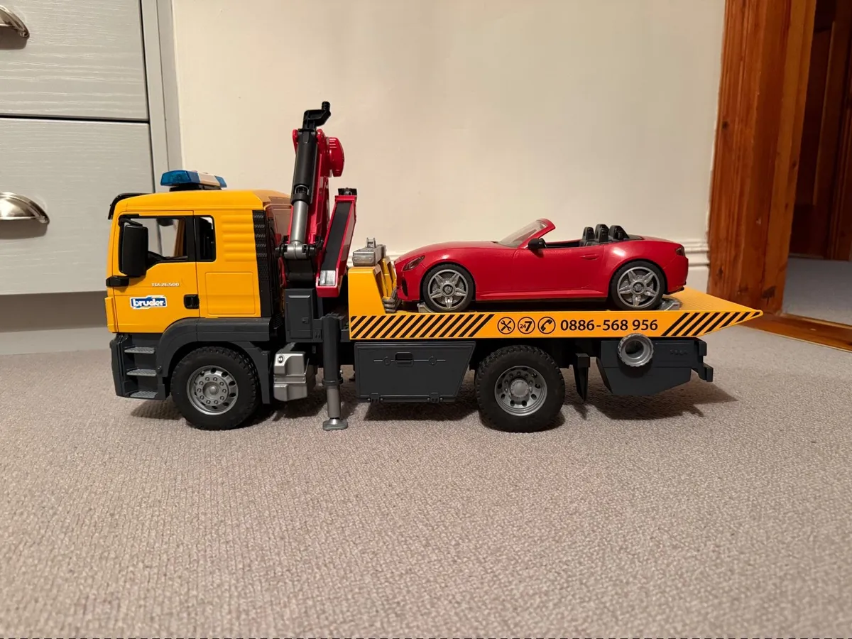 BRUDER 3750 MAN TGS TOW TRUCK WITH BRUDER ROADSTER - Image 1