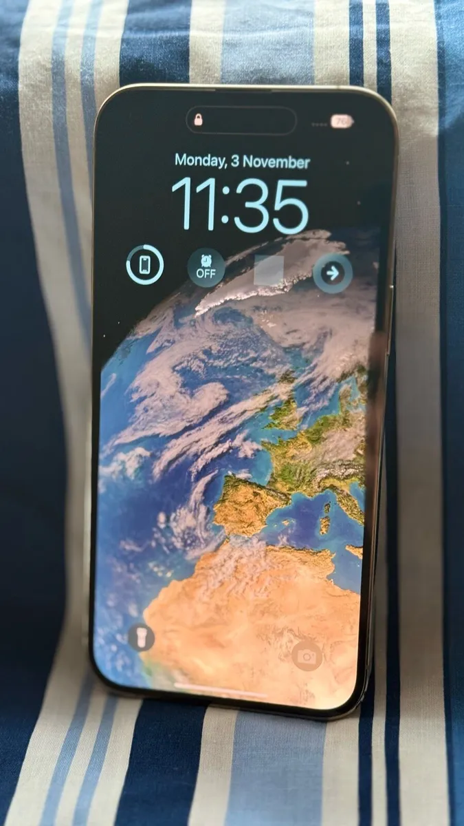 Gold iPhone 14 Pro Max with Charging Cases - Image 2