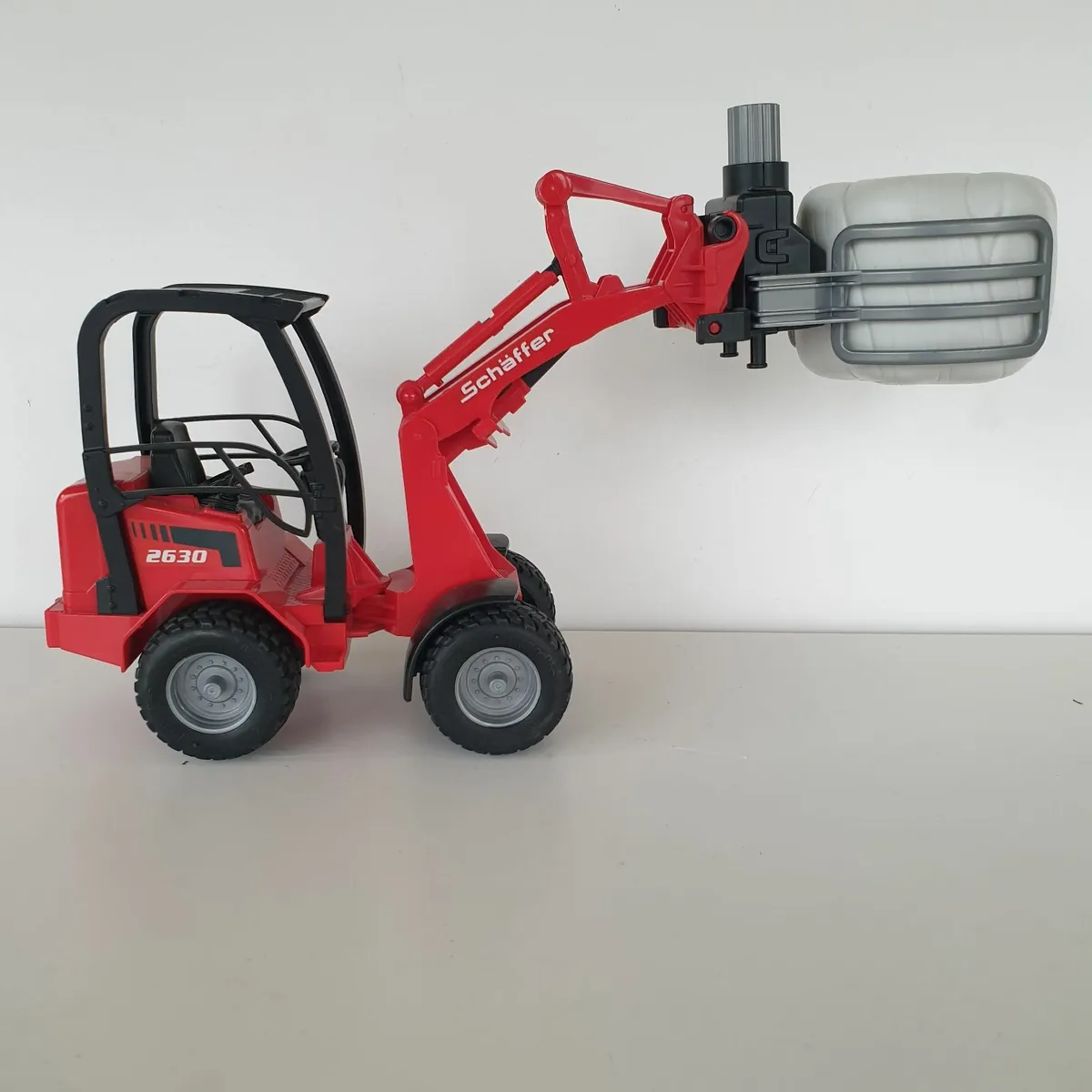 Bruder schaffer loader with bale - Image 1