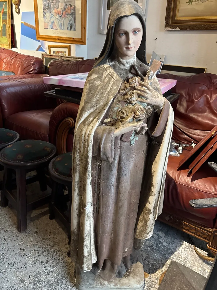 A Weathered blasted statue of saint these Lisieux. - Image 1