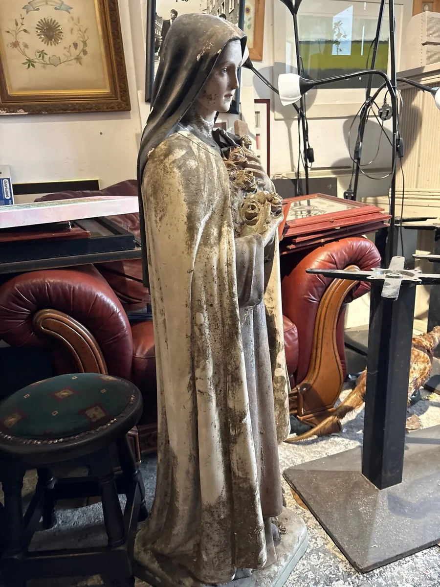A Weathered blasted statue of saint these Lisieux. - Image 2