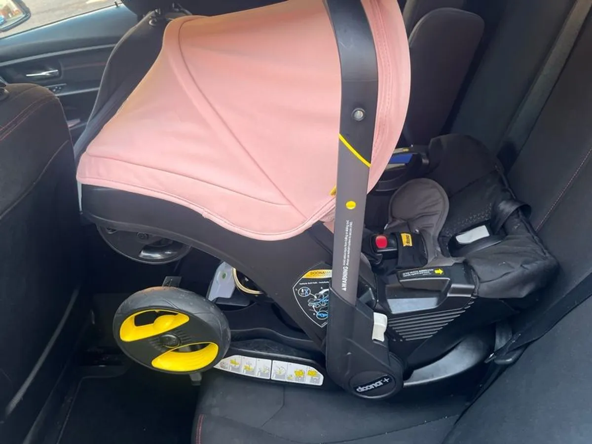 Pink Doona+ pram with base and rain cover - Image 2