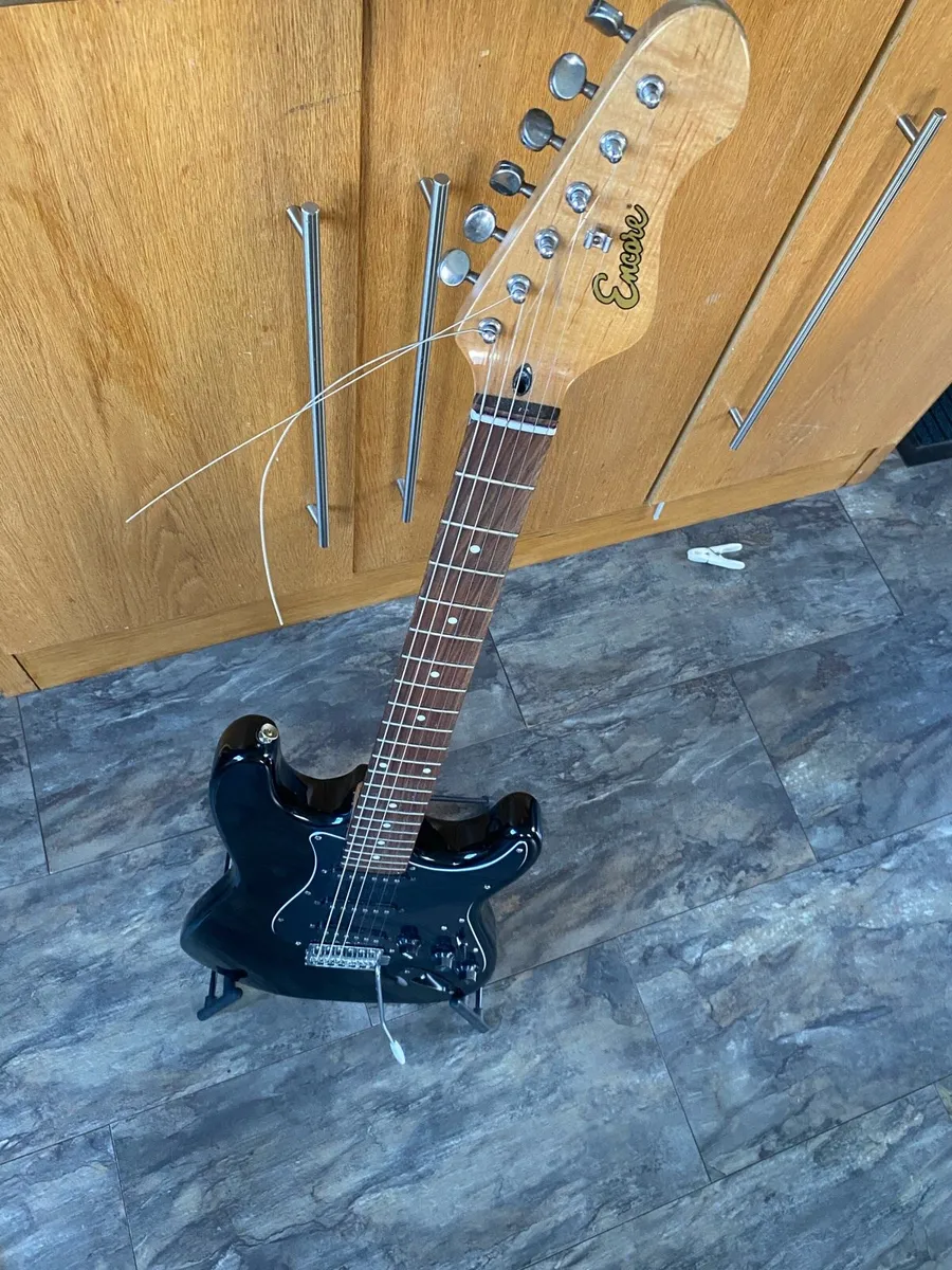 Electric guitar with stand and tuner - Image 2