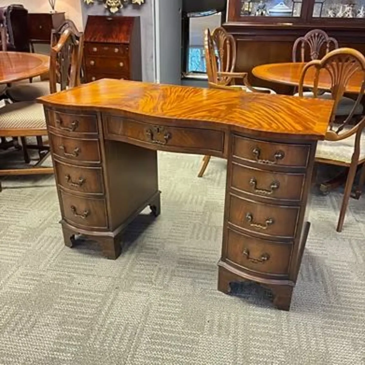 Beautiful mahogany flamed serpentine writing desk.