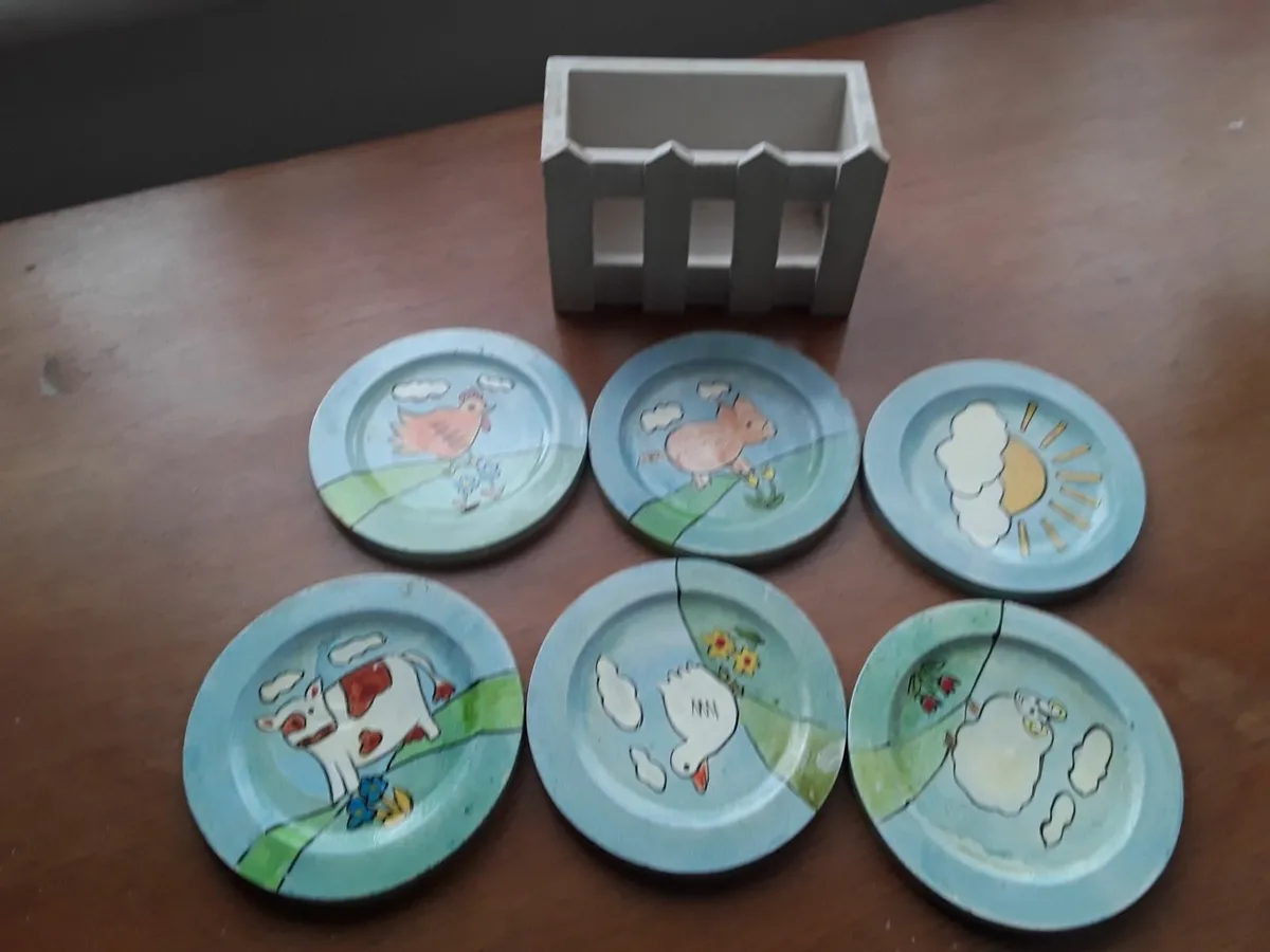 Small ceramic tea coasters in container - Image 1