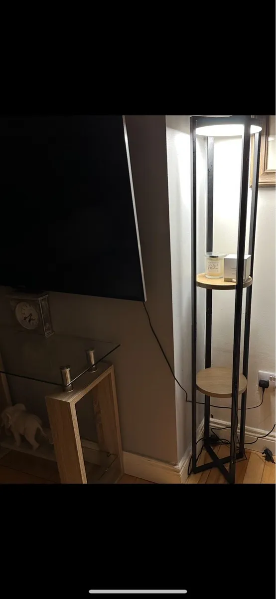 Tall lamp with shelves.
