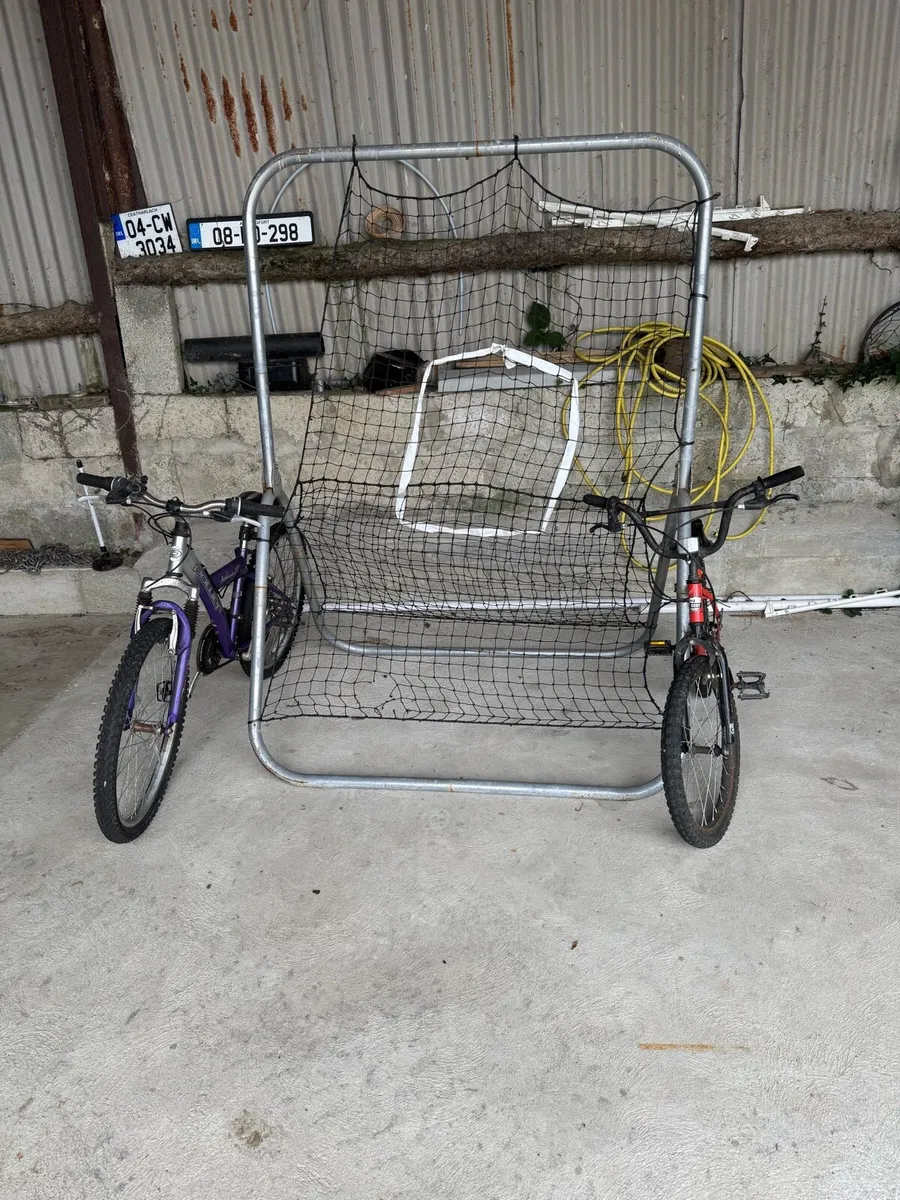 Two kids bikes 12” frame and 14” and rebounder net - Image 1