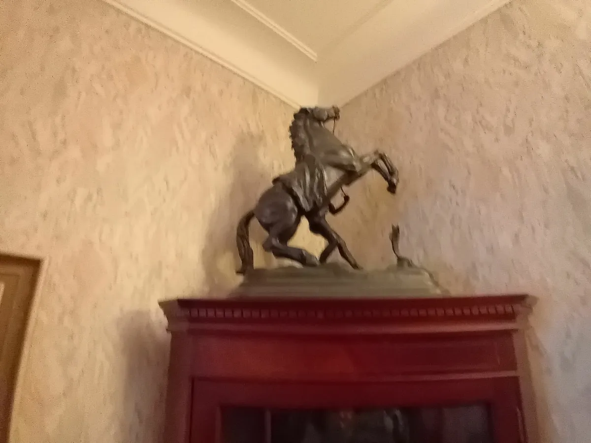 Antique horse and jockey statue